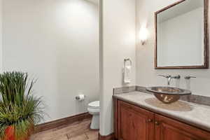 Half bath with vanity and light wood-type flooring