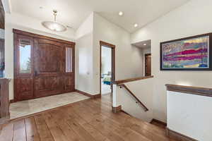 Foyer with light wood-type flooring and lofted ceiling