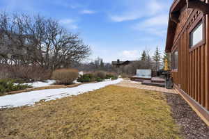 View of grassy yard featuring a deck