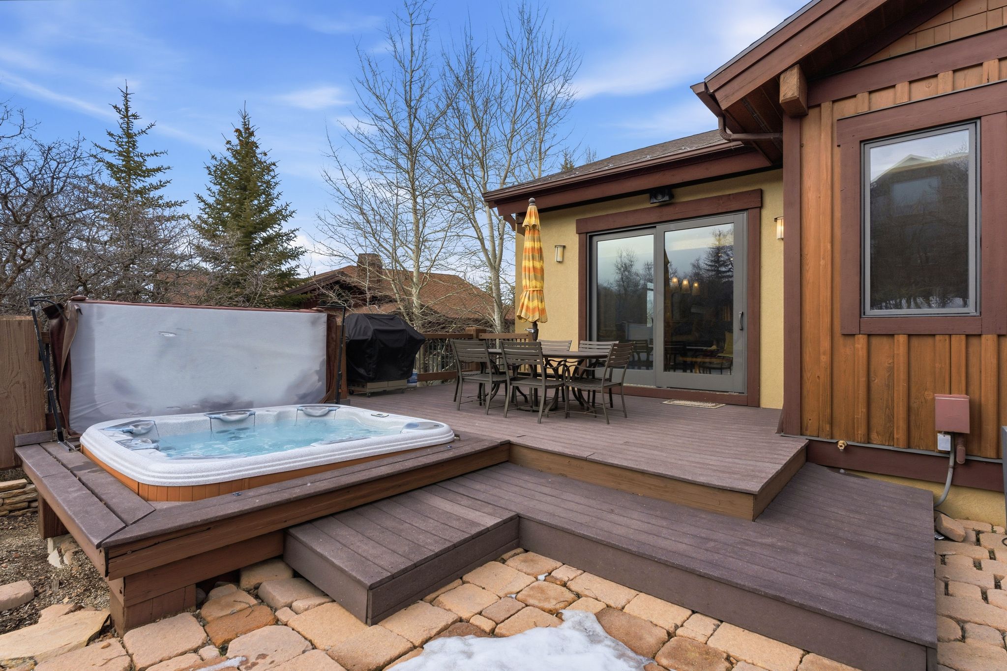 Deck with outdoor dining area and a grill