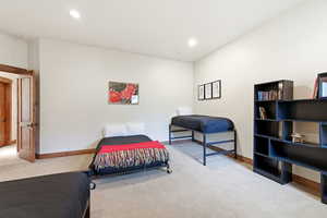 Bedroom featuring light carpet and recessed lighting