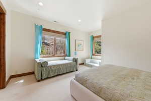Bedroom with light carpet and recessed lighting