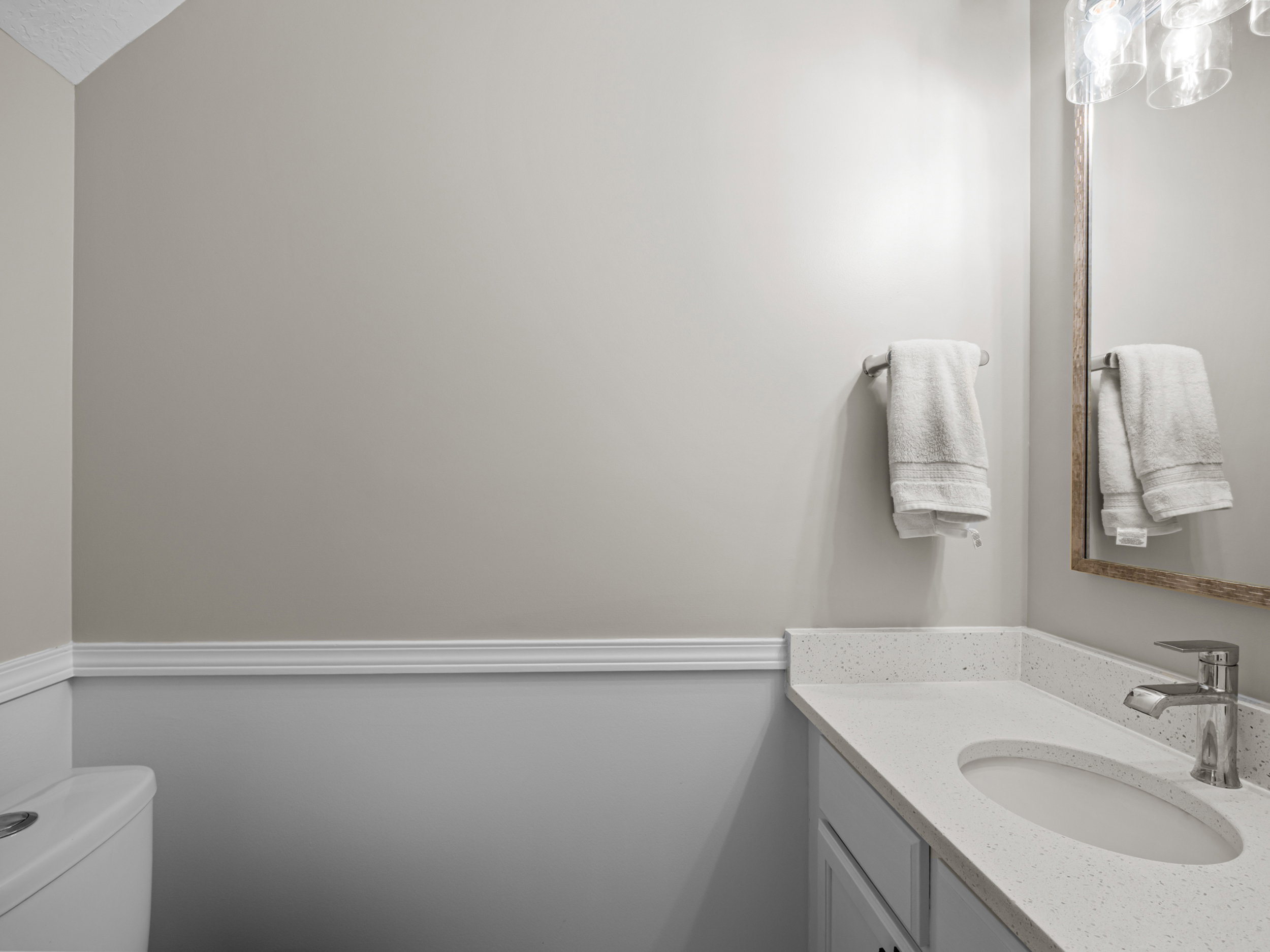 Half bathroom featuring vanity and toilet