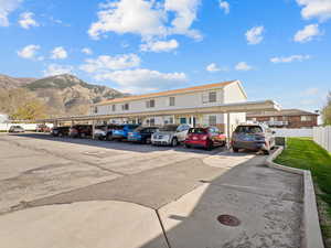 Covered parking lot featuring a mountain view