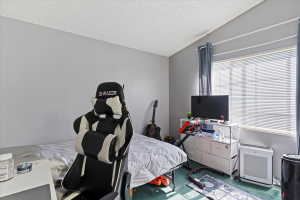 Bedroom featuring heating unit and carpet