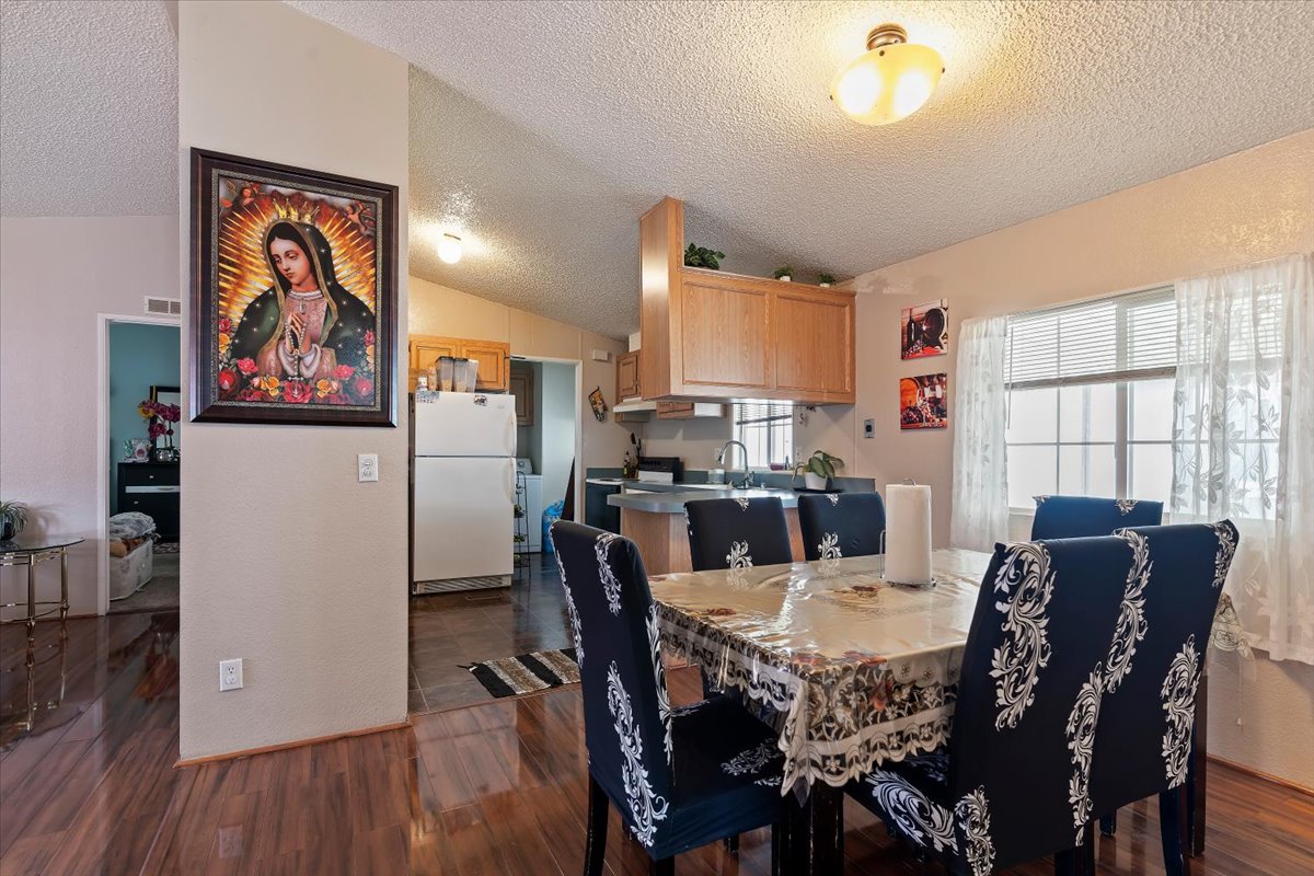 Dining room featuring dark wood-style floors