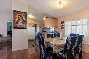 Dining room featuring dark wood-style floors