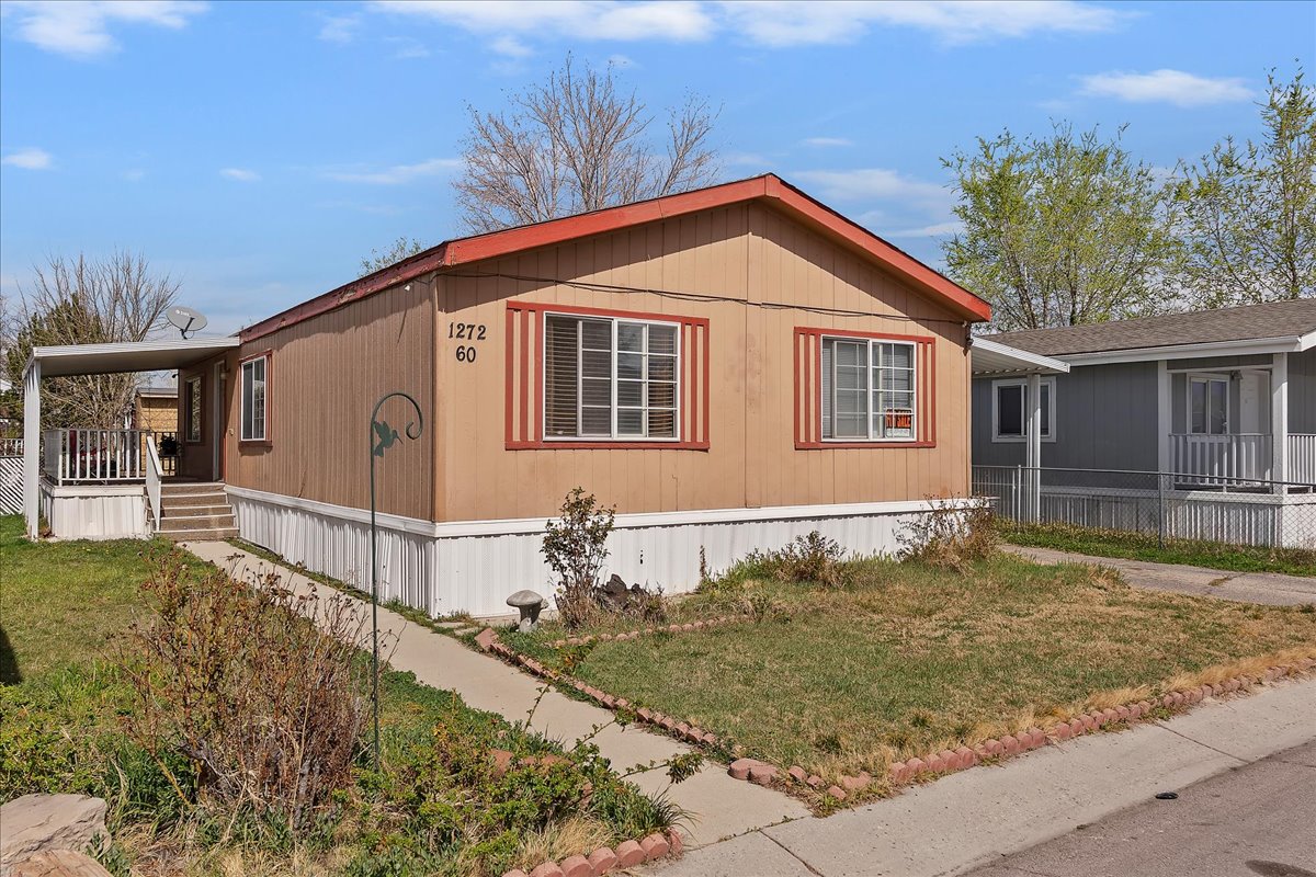 View of side of home with a yard