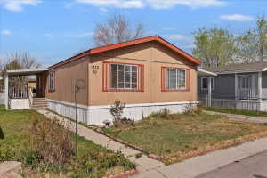 View of side of home with a yard