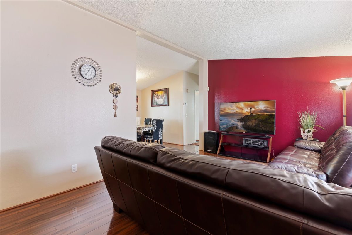 Living room with wood finished floors and a textured ceiling