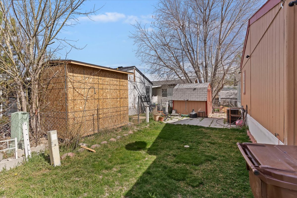 View of yard featuring a patio and a storage unit