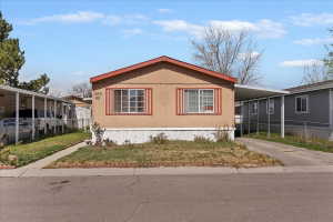 View of side of property featuring a carport and concrete driveway