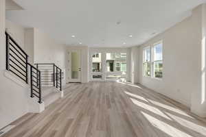 Unfurnished living room featuring light wood-style flooring and recessed lighting