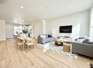 Dining space featuring light wood-style flooring and a chandelier