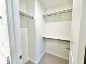 Walk in closet featuring light carpet