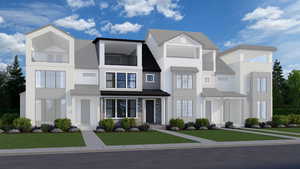 View of front of property featuring a balcony, a front yard, and stone siding