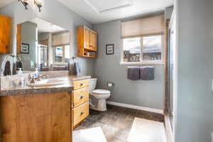 Bathroom featuring vanity, stone tile floors, and a stall shower