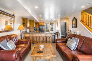 Living room with recessed lighting and light carpet