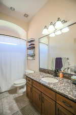 Bathroom with vanity and curtained shower