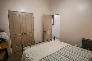 Carpeted bedroom featuring a closet