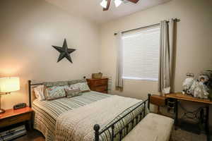 Carpeted bedroom featuring a ceiling fan