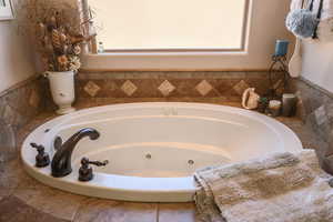 Full bath with a tub with jets