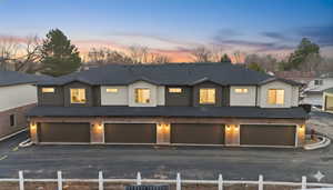 Traditional-style house featuring a garage and stucco siding