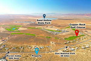 View of rural area with a mountain backdrop and a desert landscape