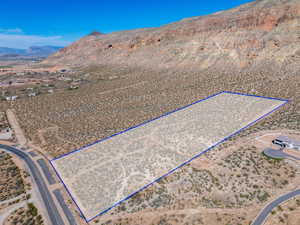 Overview of rural landscape featuring property boundaries highlighted and a mountainous background