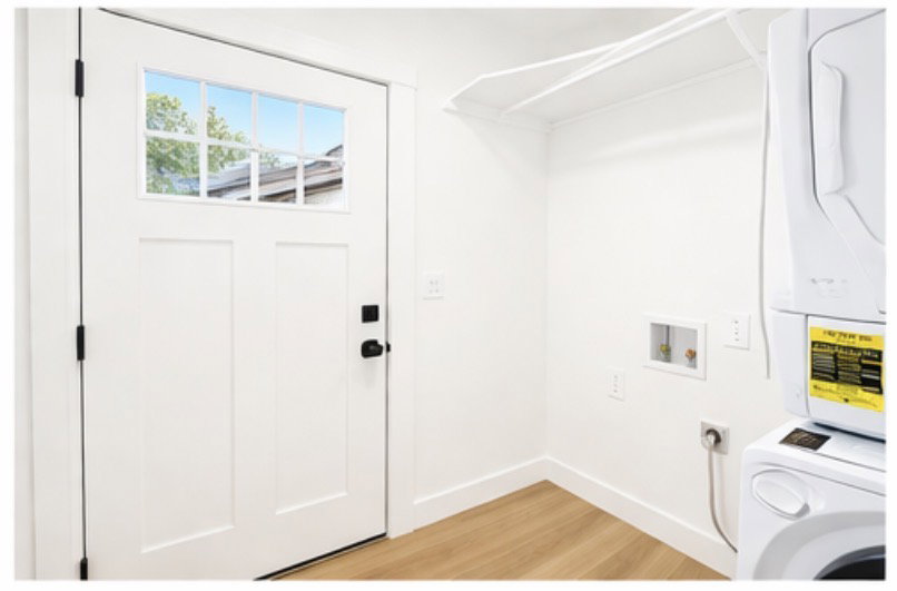 Laundry room featuring washer / clothes dryer and light wood-style floors
