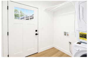 Laundry room featuring washer / clothes dryer and light wood-style floors