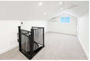 Additional living space with light colored carpet and recessed lighting