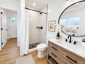 Bathroom featuring a stall shower, light wood-type flooring, and vanity