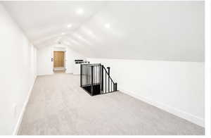 Additional living space featuring light colored carpet and recessed lighting