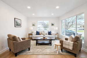 Living area featuring light wood-style floors and recessed lighting