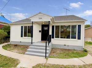 Bungalow featuring a shingled roof, crawl space, and stucco siding