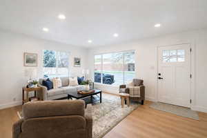 Living area featuring light wood finished floors and recessed lighting