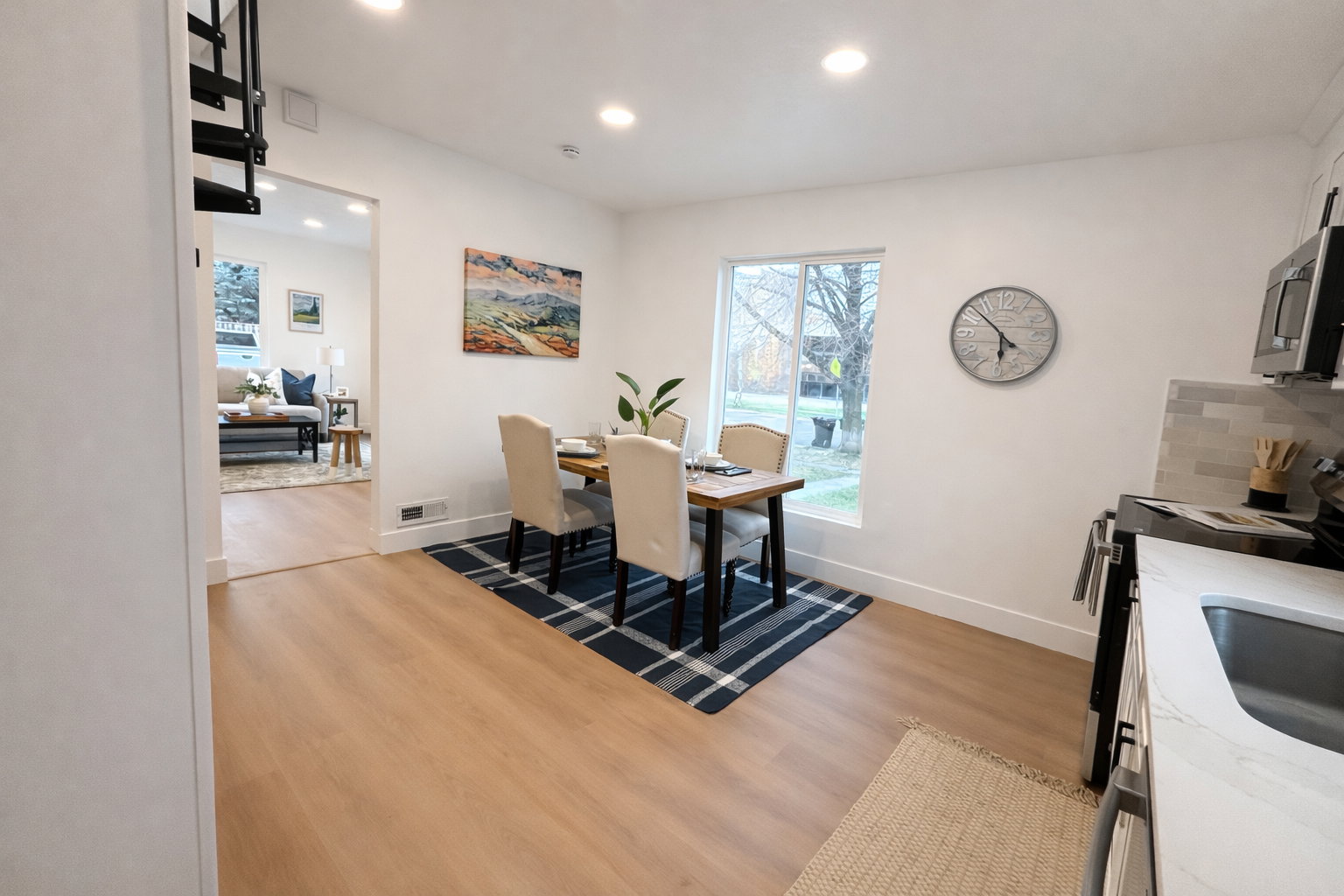 Dining area with light wood-style flooring and recessed lighting