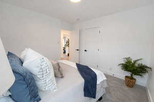 Carpeted bedroom featuring baseboards