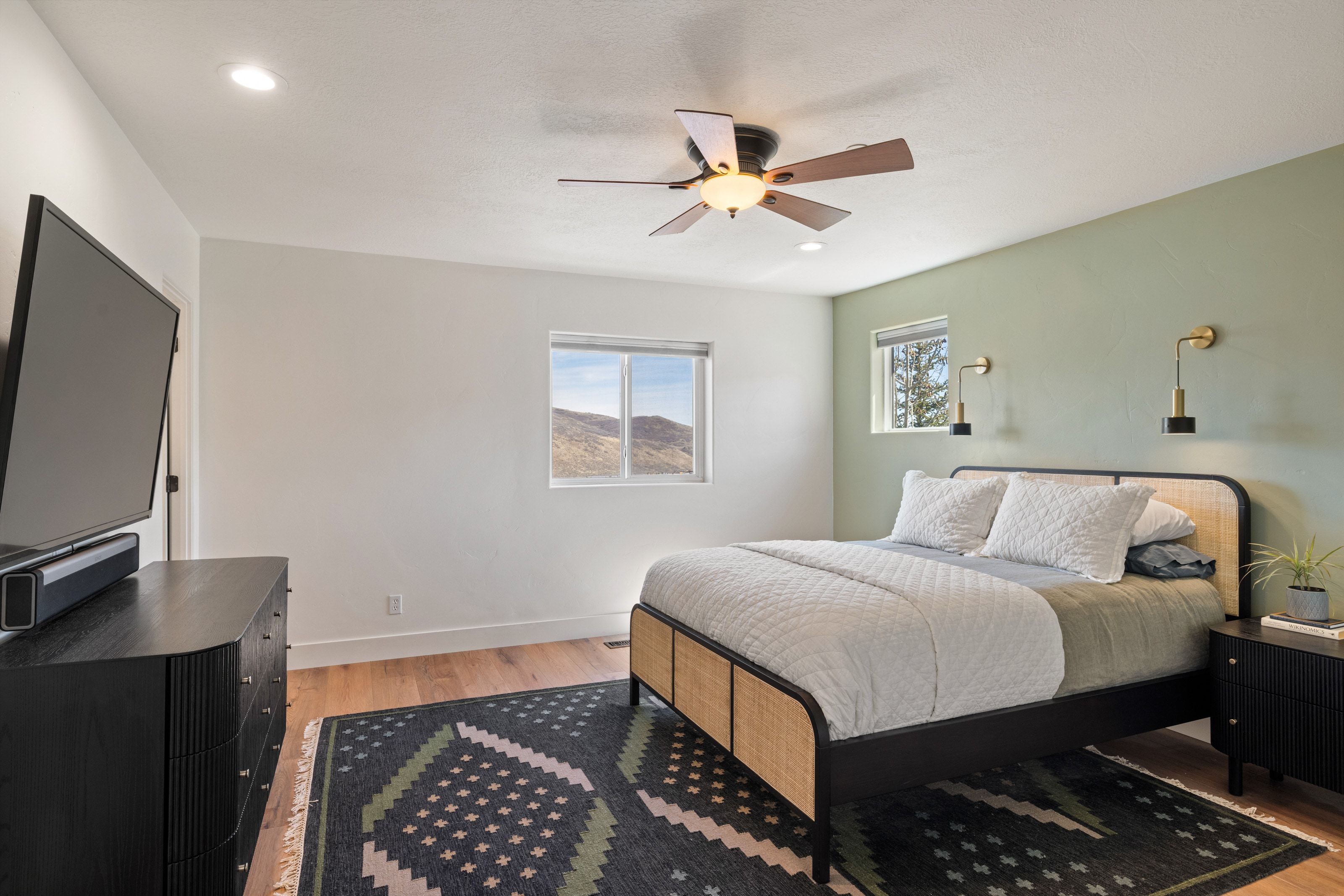 Bedroom with light wood finished floors and ceiling fan