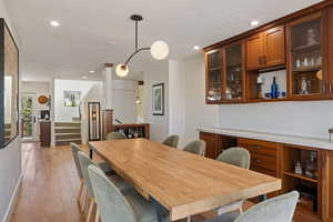 Dining space with light wood-type flooring and recessed lighting