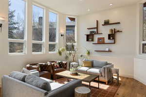 Living area with wood finished floors and recessed lighting