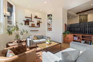 Living area featuring wood finished floors and recessed lighting