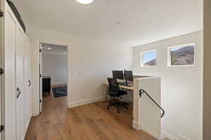 Office area featuring light wood-type flooring and baseboards