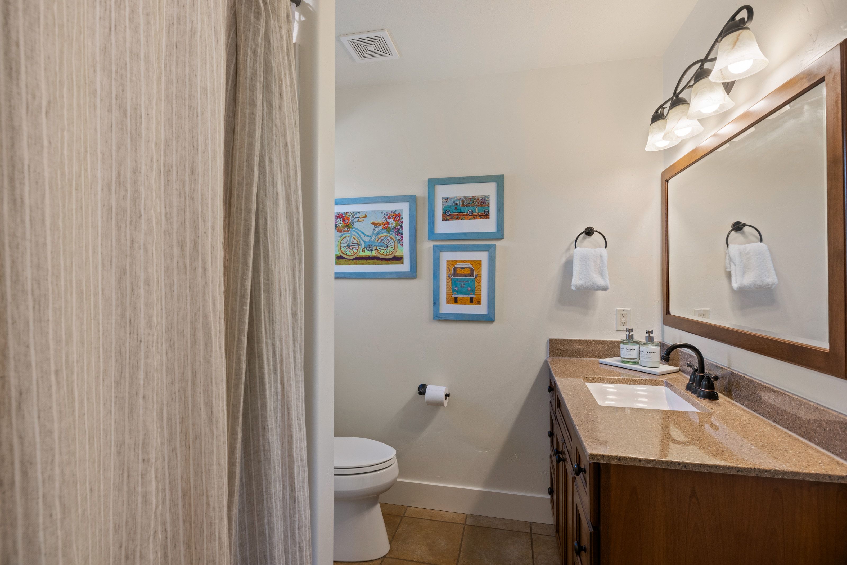 Full bathroom featuring vanity, a shower with curtain, and light tile patterned floors
