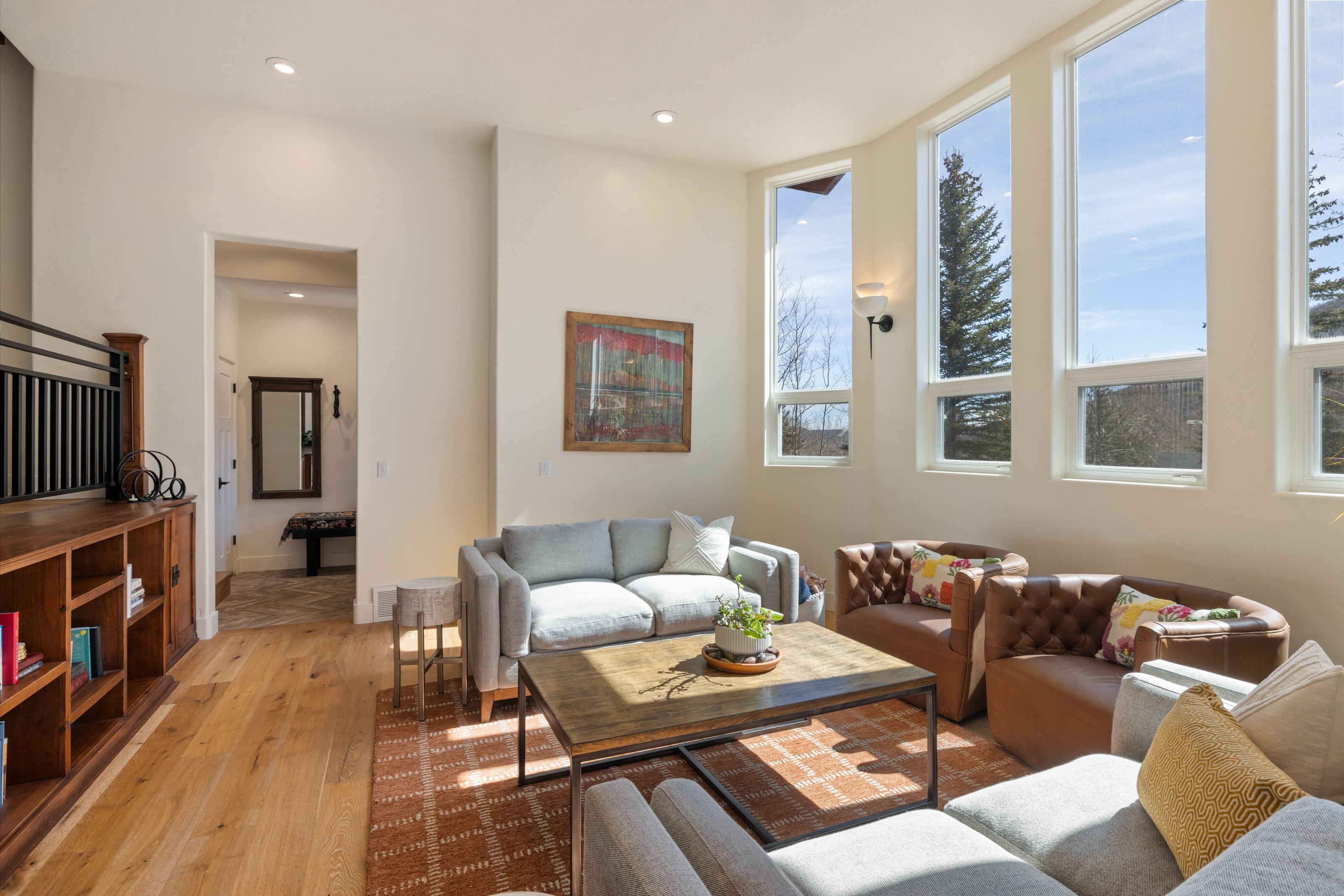 Living area with light wood-style floors and recessed lighting