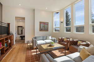 Living area with light wood-style floors and recessed lighting