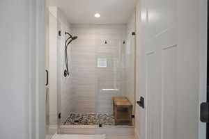 Bathroom with a shower stall and recessed lighting