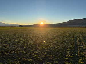 Water view featuring a mountainous background and rural landscape