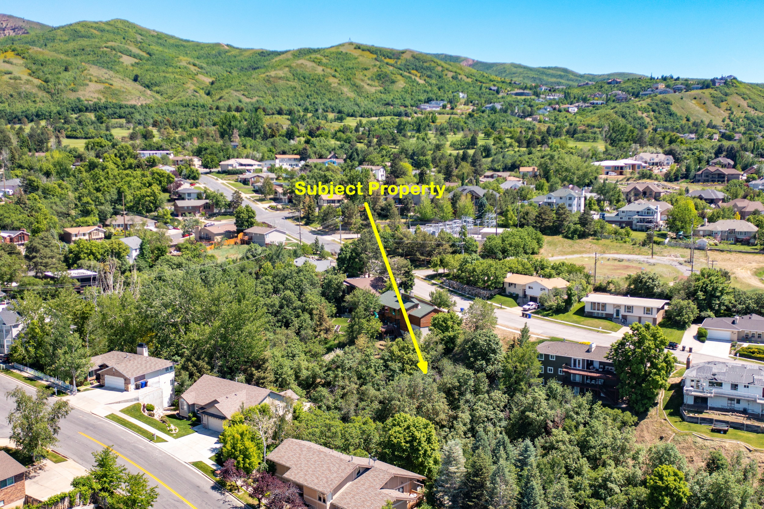 Aerial perspective of suburban area with a mountainous background